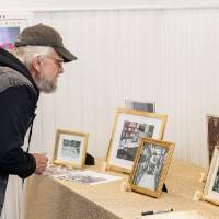 Event guests looking at photos set out at table
